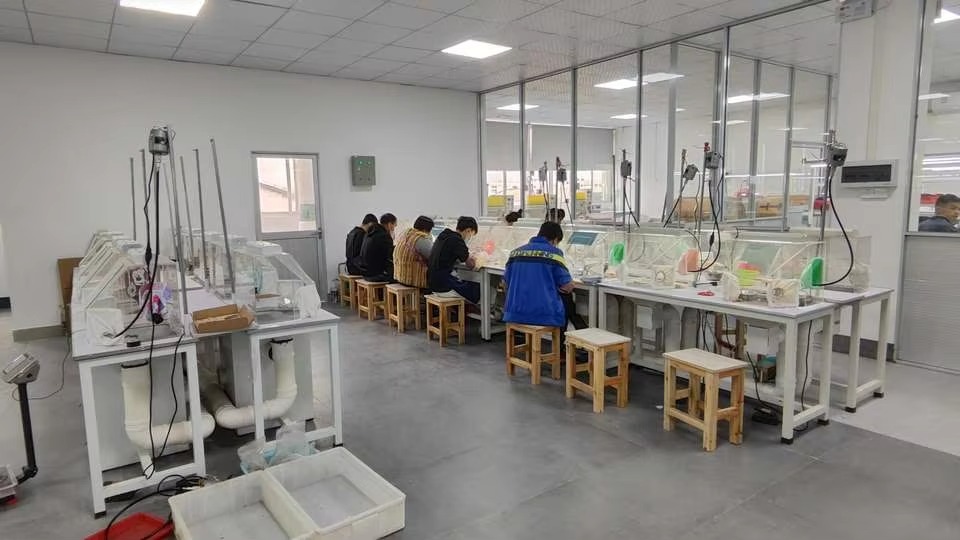five workers are crafting jewelry at workshop in carat island's jewelry manufacturer
